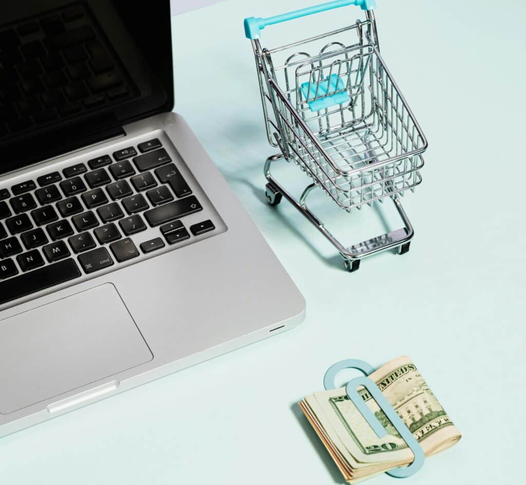 Open laptop with a small shopping cart illustrating digital marketing strategies for cleaning services