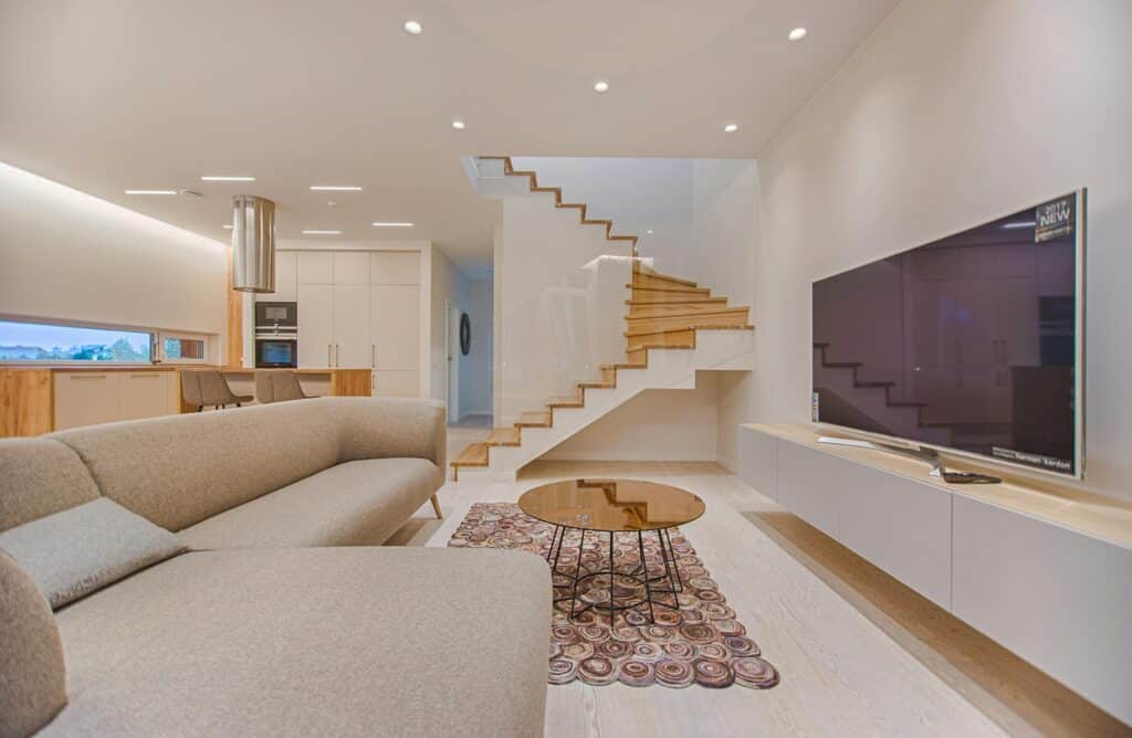 Bright and spotless living room with a clean staircase, reflecting the high-quality standards of a cleaning service's work