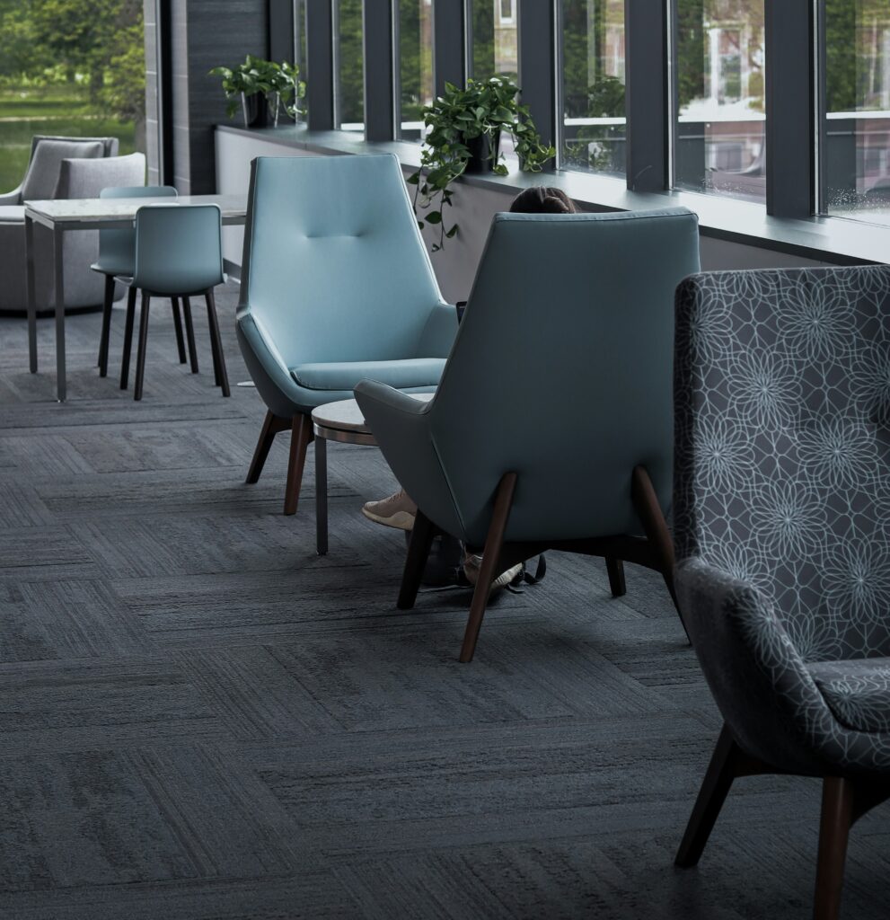 Modern office space with stylish chairs and beautifully maintained carpet showcasing the effectiveness of encapsulation cleaning.