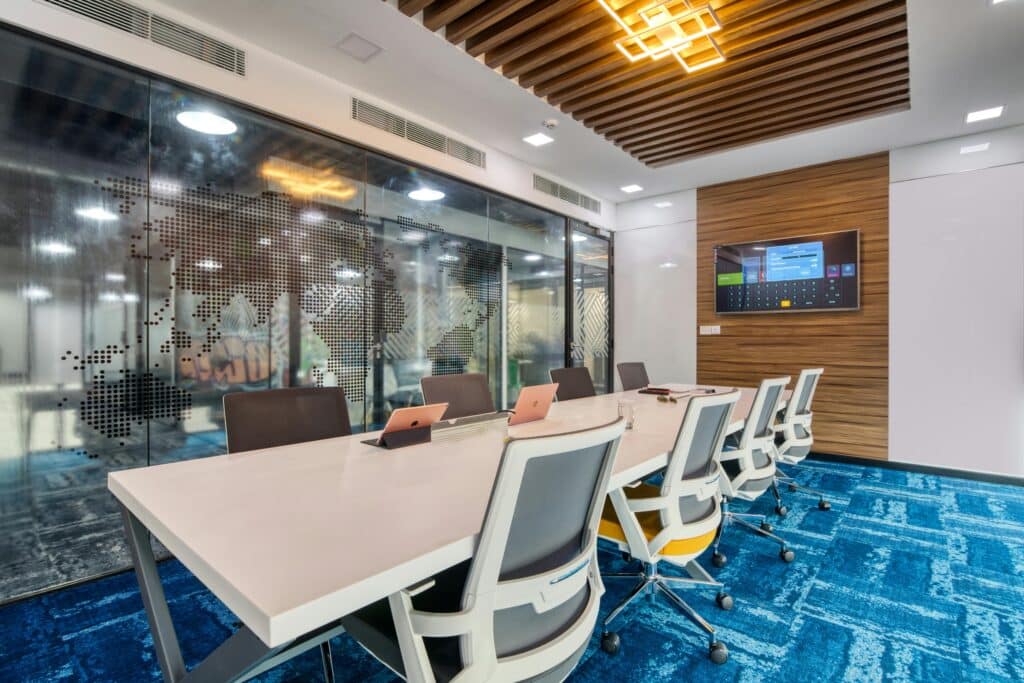 Modern office with blue carpet and conference table