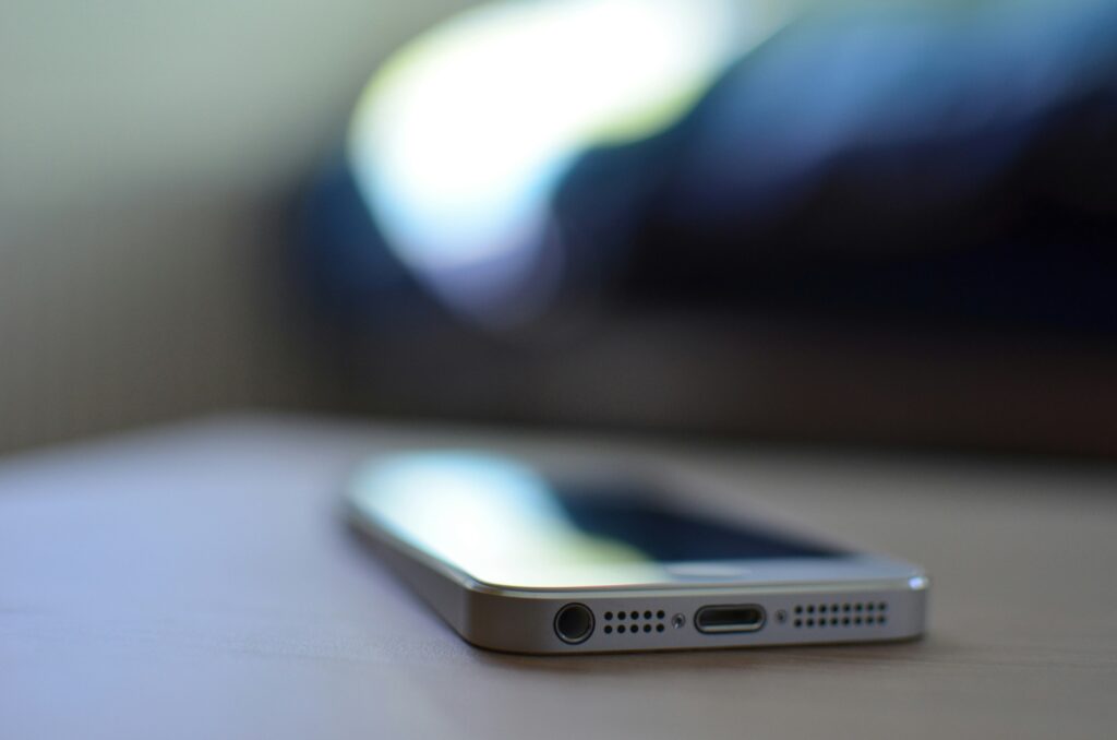 Close-up image of a smartphone lying on a surface, representing text marketing for cleaning services.